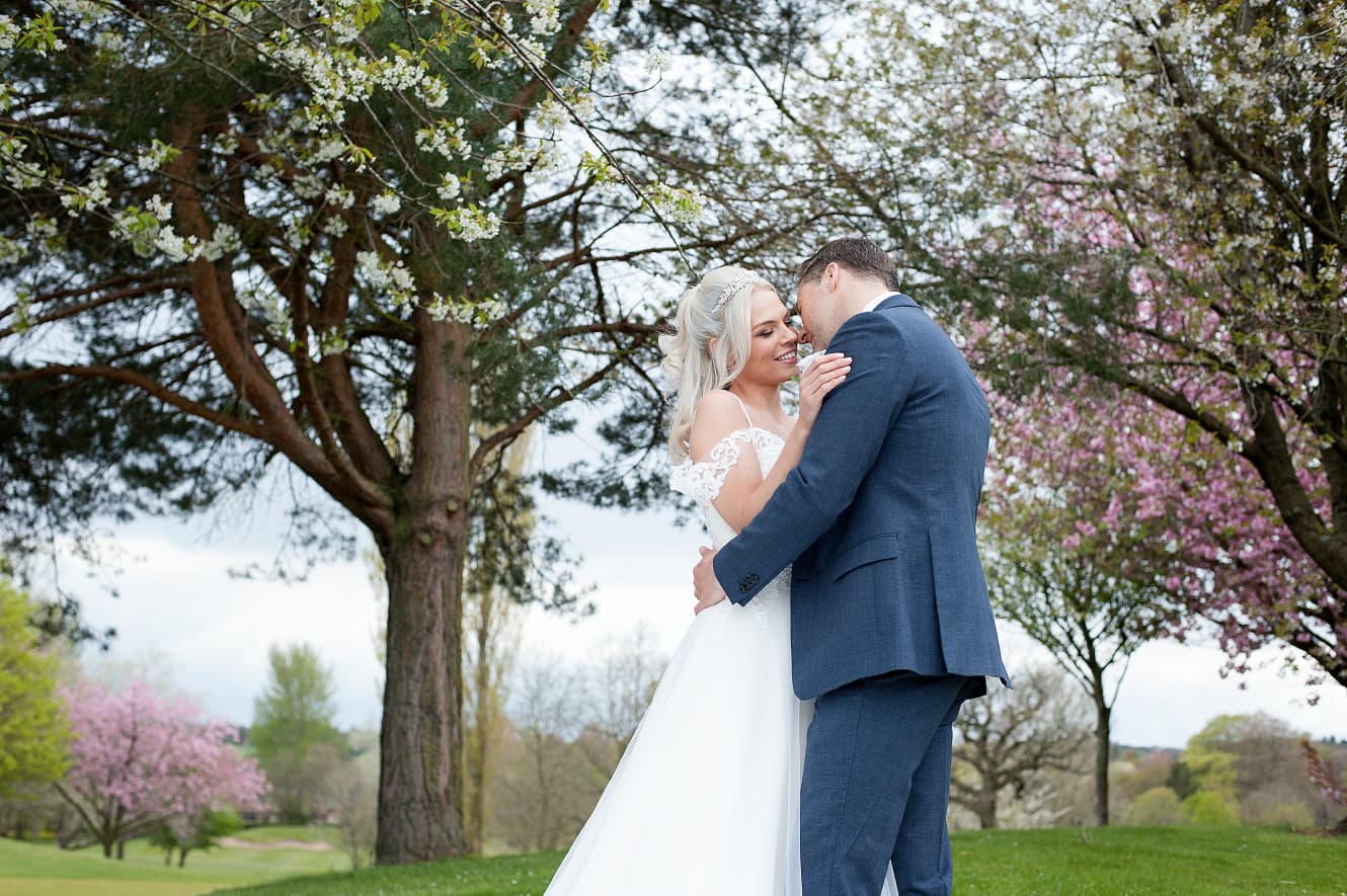 Couple embracing on the balcony on a golf course